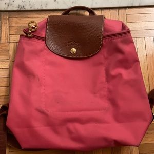 Used pink Long champ back pack. There are stains and some wear. Please see pics.